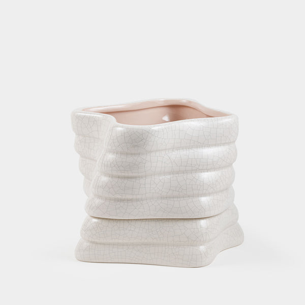 A white ceramic self-watering pot designed for plant growth with visible root monitoring feature.